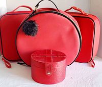 Front view showing all four red makeup cases