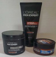 All three L'Oreal Men Expert products: Defining Gel tube, Sculpting Paste jar, Messy Hair Clay Pomade jar