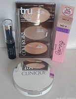 Group shot of all four cosmetics showing brands and packaging