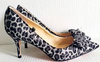 profile view of left shoe showing leopard print fabric, bow, heel