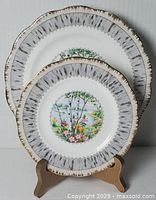 Both plates on stand showing size difference and pattern