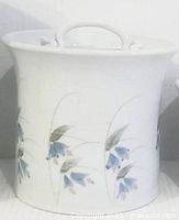 Front view of ceramic canister showing painted Wildgrass design