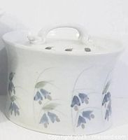 Side view of canister showing motif