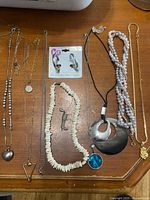 All ten jewellery pieces laid out on table