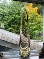 Full view of tall art glass vase showing height, color pattern, and side opening