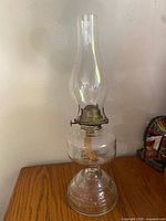 Full view glass oil lantern on wooden surface