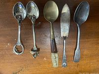 Group of five utensils laid out showing fronts