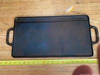 Top view of full griddle with tape measure showing length ~23 in
