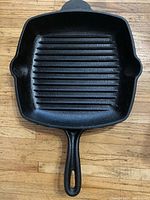 Top view of square cast iron grill skillet showing ridged interior and handle