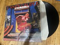 Front cover of album with vinyl partially removed