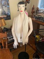 Front view of mannequin showing torso, head, arms, scarf