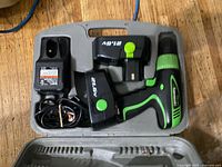 Open case showing drill, two batteries and charger