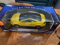 Front and side view of boxed yellow Honda Accord die-cast model