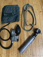 Blood pressure cuff, stethoscope and otoscope grouped