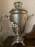 Front view of full samovar showing body, spigot, handles, base