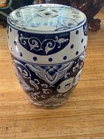 Full view of blue and white ceramic garden stool showing pattern and top vent
