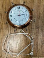 Front view showing entire Ingraham wall clock with power cord