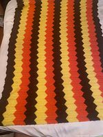 Full view of crocheted blanket showing size and chevron pattern