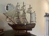 Starboard side view of wooden HMS Bounty model ship on stand