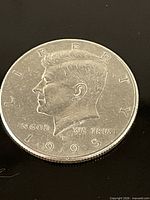 Obverse showing year 1995, JFK profile, LIBERTY and IN GOD WE TRUST