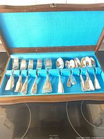 Open flatware chest showing all pieces laid in slots