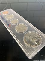Five coins in sealed plastic case