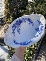 Top view showing flow blue floral interior and gilt rim