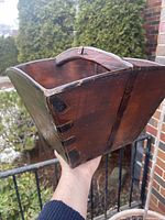 Three-quarter view showing exterior wood, dovetail joints, iron bands, handle