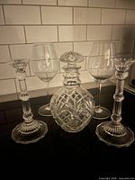 Front view of entire lot: decanter, two candlesticks, two wine glasses