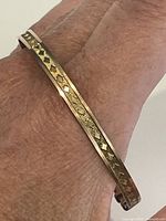 bangle worn on wrist showing exterior diamond motif