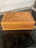 Top view showing carved floral lid of wooden puzzle box