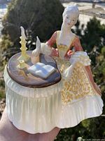Full view of Royal Doulton “Meditation” figurine showing lady, desk, book, quill and candle