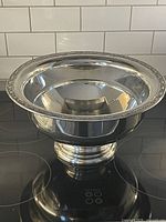 Full view of silverplate punch bowl on stovetop