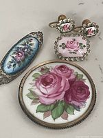 Group view of five floral jewelry pieces