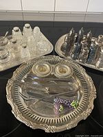 Group shot of trays with silver and crystal pieces