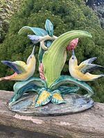 Full view of Stangl pottery hummingbird figurine on outdoor ledge