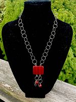 Full view of sterling link chain necklace with carnelian pendant displayed on bust