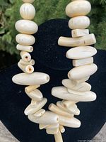 Close-up of irregular cream beads showing shape and striations