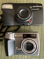 Front view Olympus Zoom2000 and Kodak EasyShare Z730 cameras