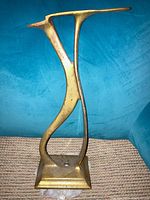 Front view of solid brass doorstop showing sculptural shape