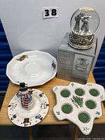 All four items on table: snow globe, oval platter, snowman plate, Spode tealight holder