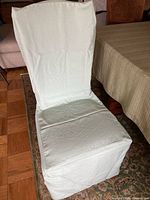 Chair with seafoam slipcover front view