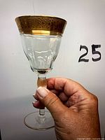 Full view of cordial glass showing gold rim, bowl, stem and foot