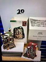 Both ceramic buildings and their boxes shown together