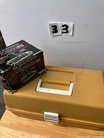 Tackle box closed with Shimano reel box beside it