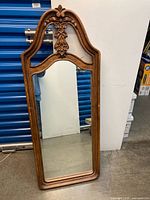Full view of one carved wood mirror