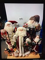 Group shot of all five Santa figurines on display