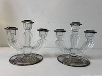 Front view of both candleholders showing overall form and silver overlay bases