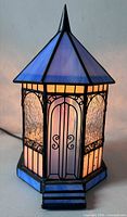 Front view of stained glass gazebo lamp illuminated