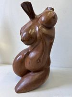 Front angle of carved hardwood female torso sculpture